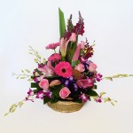 Basket of oriental lilies, roses, gerberas and orchids.