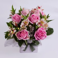 Box arrangement of roses and alstroemeria.