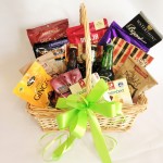 Hamper of beers, cheeses and other savoury and sweet items.