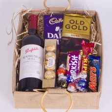 Hamper with bottle of red wine and chocolates.